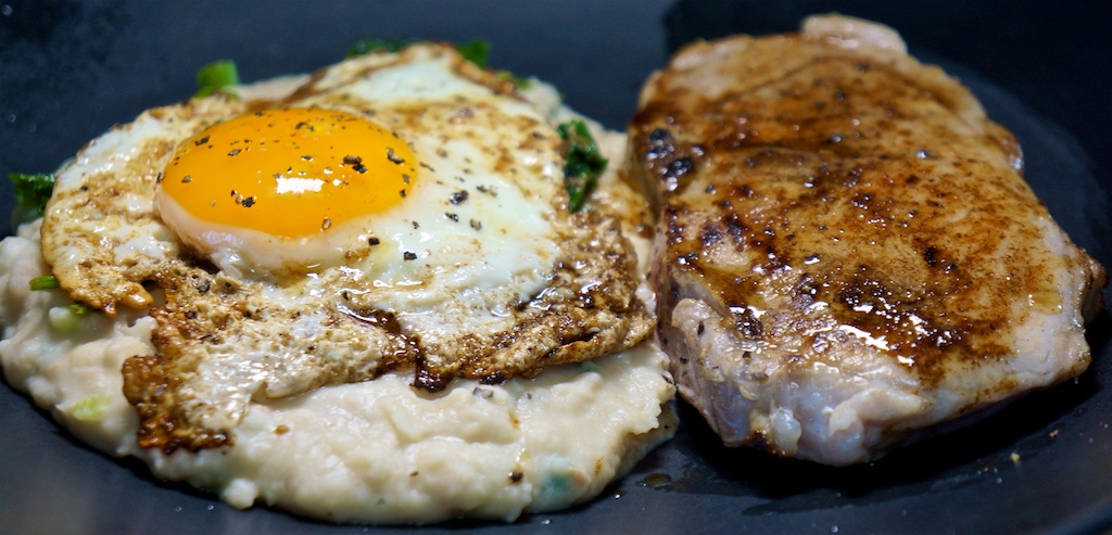 May 25: Cheese & Tomato on an Onion Bagel; Seared Pork Loin Chops; Mashed White Beans with Kale, Parmesan, and a Fried Egg